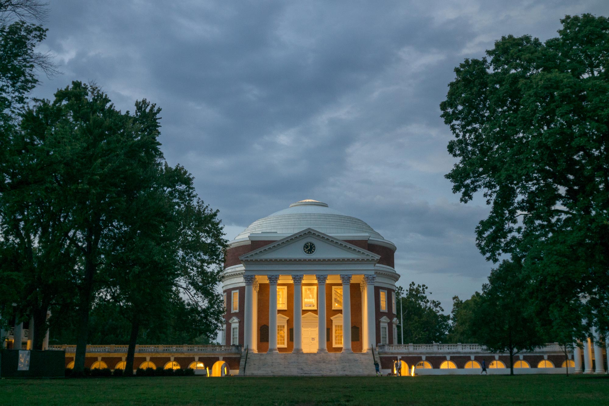 Rotunda at night with all of its lights on as the sky is cloudy