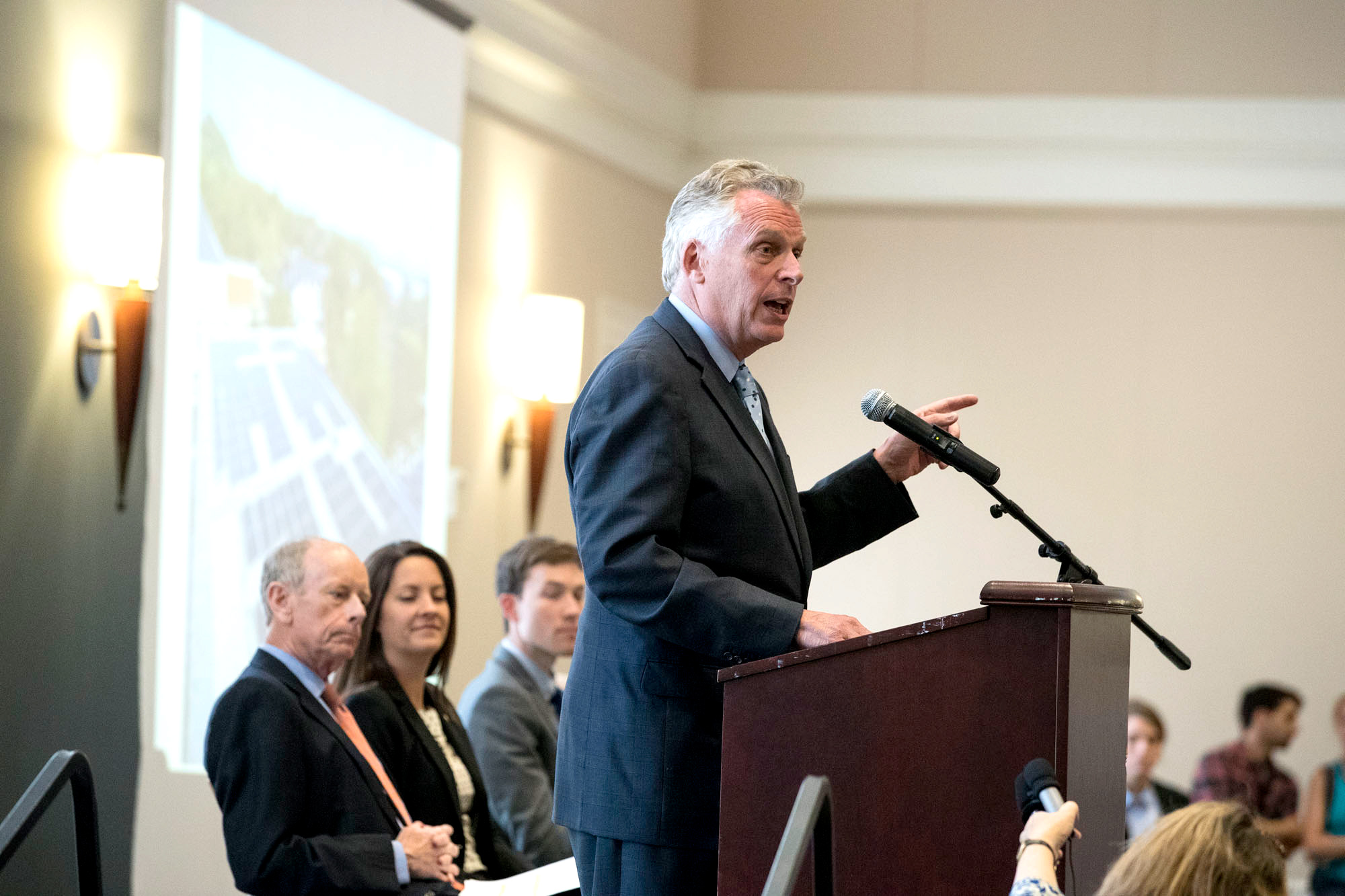 McAuliffe speaking at a podium